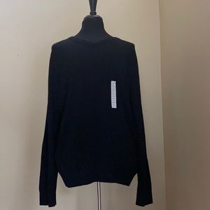 Black V-neck sweater.